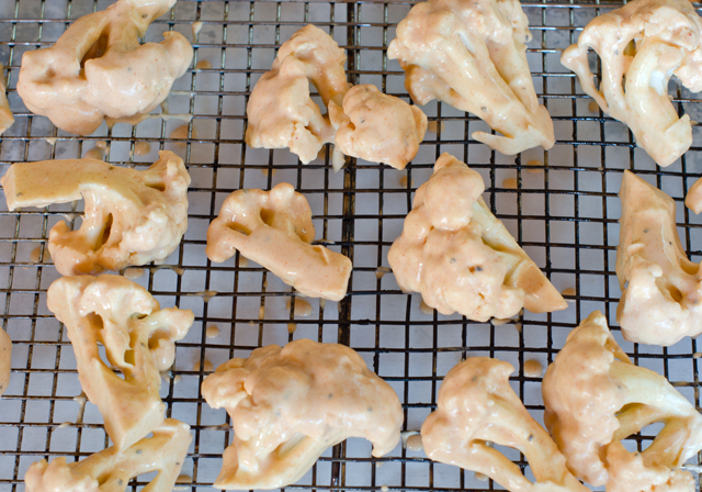 Dip cauliflower pieces in the batter. Place on a wire rack above the parchment lined baking tray for easy clean up.